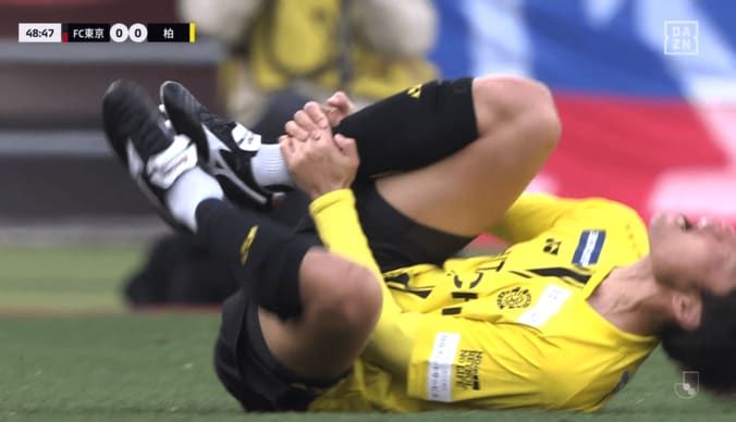 足首を押さえて痛がる垣田