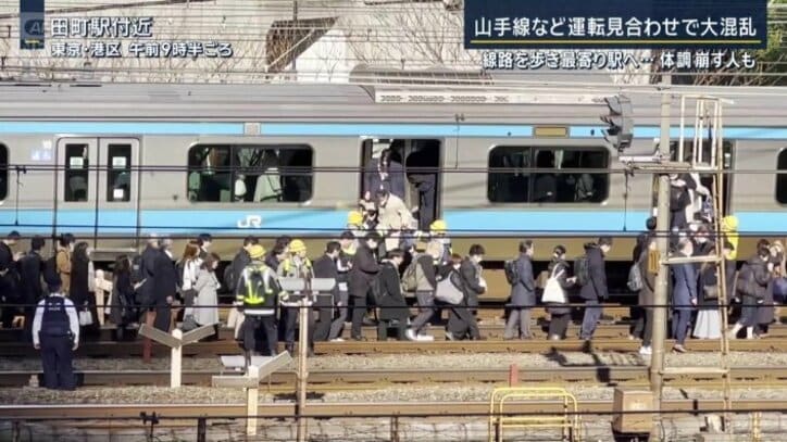 線路の上を歩く乗客