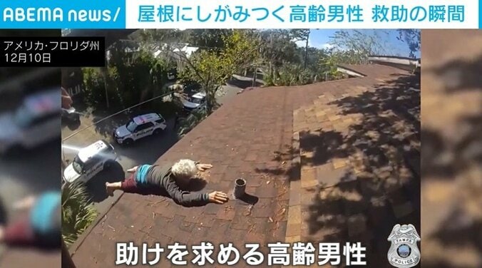 屋根にしがみつく男性