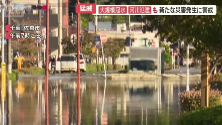 冠水した道路に入っていくトラック